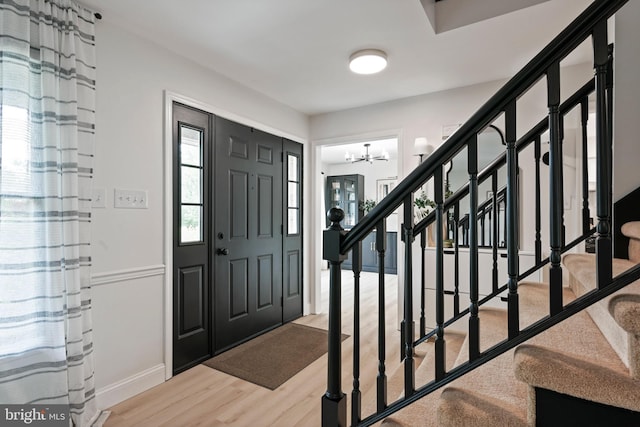 329 Hunter Path Rd, Hummelstown, PA 17036 - foyer with wood finished floors, stairway, a chandelier, and baseboards