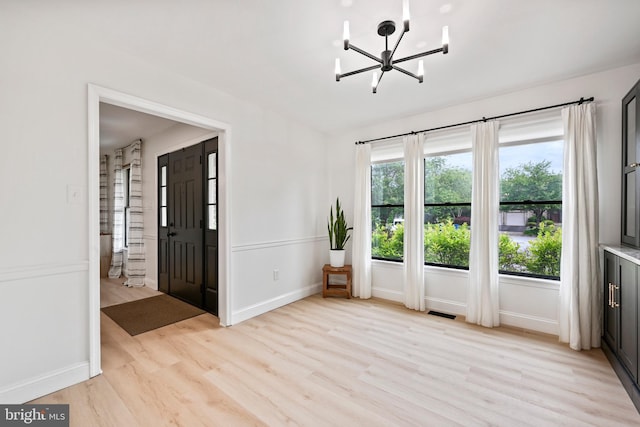 329 Hunter Path Rd, Hummelstown, PA 17036 - empty room featuring light wood-style flooring, a chandelier, and baseboards