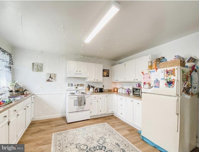 12 Pennsylvania Ave, Cumberland, MD 21502 - kitchen with white appliances, under cabinet range hood, white cabinetry, and light wood-style floors