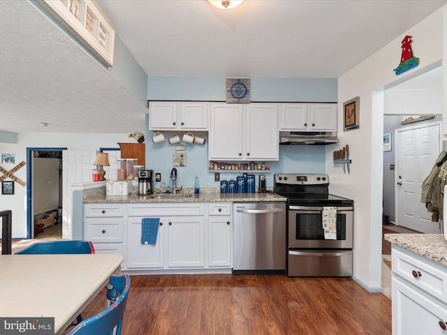 4333 Declaration Cir, Belcamp, MD 21017 - kitchen with appliances with stainless steel finishes, under cabinet range hood, a sink, white cabinetry, and dark wood-type flooring