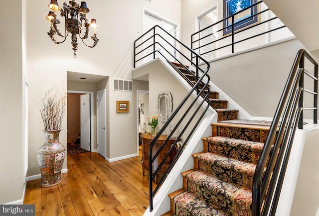 184 Pitman Downer Rd, Sewell, NJ 08080 - stairway with a towering ceiling, a chandelier, and wood-type flooring