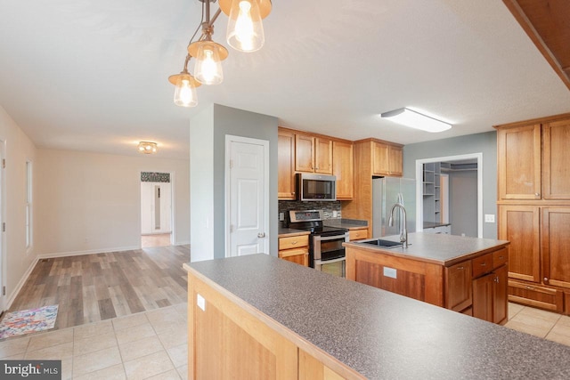 6081 Dotts Ln, Penn Laird, VA 22846 - kitchen with appliances with stainless steel finishes, an island with sink, a sink, tasteful backsplash, and light tile patterned floors