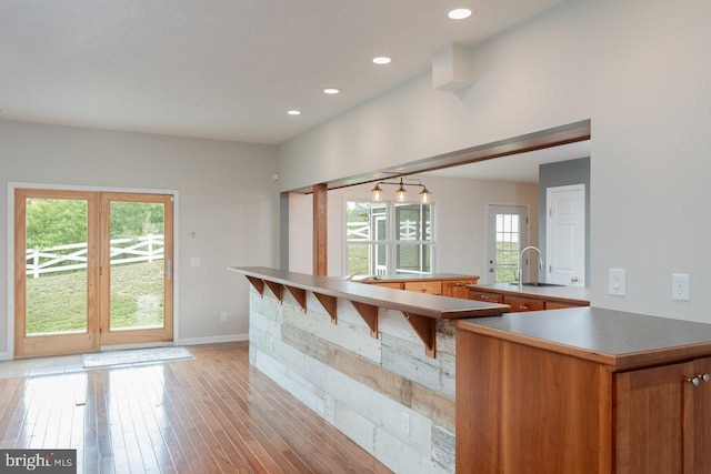 6081 Dotts Ln, Penn Laird, VA 22846 - kitchen with a sink, light wood-style flooring, baseboards, recessed lighting, and brown cabinets