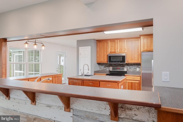 6081 Dotts Ln, Penn Laird, VA 22846 - kitchen with stainless steel appliances, a center island with sink, decorative backsplash, a sink, and light countertops