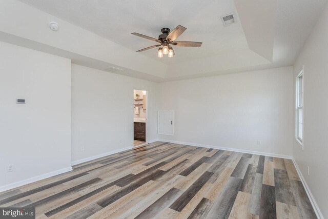 6081 Dotts Ln, Penn Laird, VA 22846 - unfurnished room with a raised ceiling, a ceiling fan, wood finished floors, and baseboards