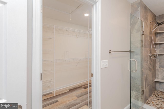 6081 Dotts Ln, Penn Laird, VA 22846 - bathroom with a stall shower, wood finished floors, recessed lighting, and a walk in closet