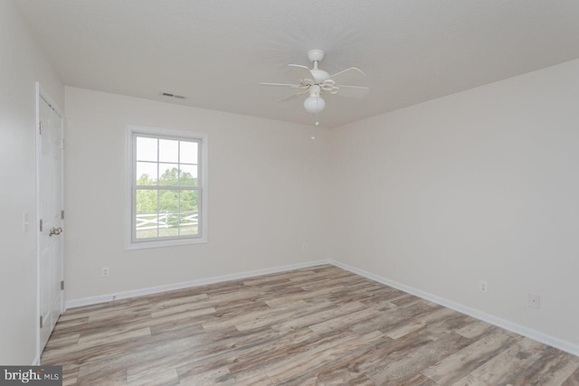 6081 Dotts Ln, Penn Laird, VA 22846 - unfurnished room with light wood finished floors, a ceiling fan, and baseboards