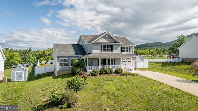 6081 Dotts Ln, Penn Laird, VA 22846 - view of front facade featuring a porch, concrete driveway, a garage, a mountain view, and central AC unit
