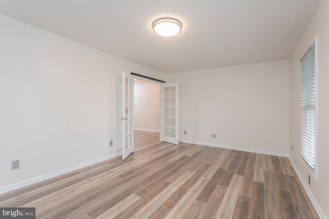 6081 Dotts Ln, Penn Laird, VA 22846 - unfurnished room featuring french doors, wood finished floors, and baseboards