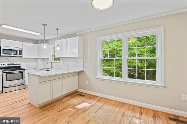2249 Gunsmith Sq, Reston, VA 20191 - kitchen with stainless steel appliances, a sink, baseboards, decorative backsplash, and white cabinets