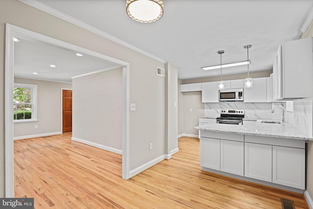 2249 Gunsmith Sq, Reston, VA 20191 - kitchen with electric range, a sink, light wood finished floors, light stone countertops, and ornamental molding