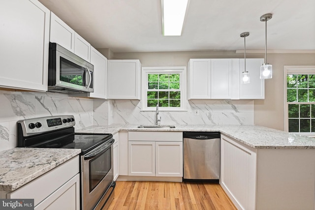2249 Gunsmith Sq, Reston, VA 20191 - kitchen with stainless steel appliances, a sink, a peninsula, and white cabinets