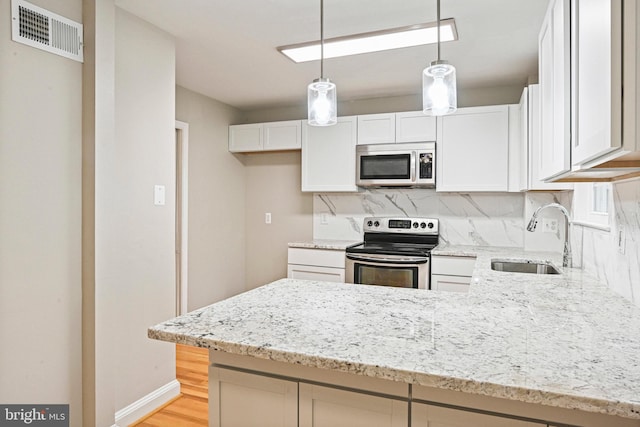 2249 Gunsmith Sq, Reston, VA 20191 - kitchen with stainless steel appliances, a sink, tasteful backsplash, and light stone countertops
