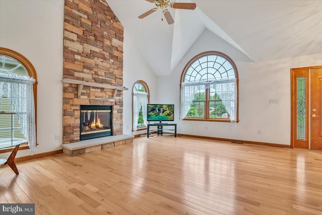 280 Center Rd, Lehighton, PA 18235 - unfurnished living room featuring plenty of natural light, hardwood / wood-style flooring, a ceiling fan, high vaulted ceiling, and a fireplace