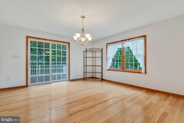 280 Center Rd, Lehighton, PA 18235 - unfurnished room with hardwood / wood-style floors, a chandelier, plenty of natural light, and baseboards