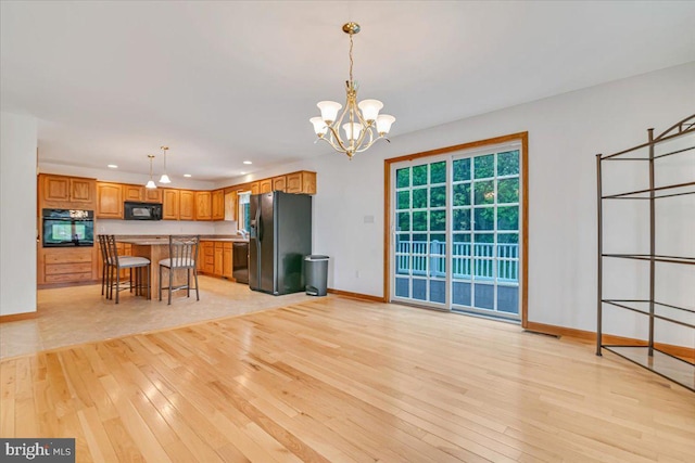 280 Center Rd, Lehighton, PA 18235 - kitchen with black appliances, light wood-style flooring, recessed lighting, baseboards, and a chandelier