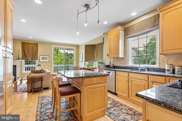 1015 Riverview Ln, Conshohocken, PA 19428 - kitchen with stainless steel dishwasher, a sink, open floor plan, light wood-style flooring, and ornamental molding