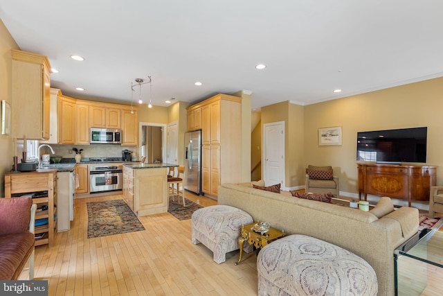 1015 Riverview Ln, Conshohocken, PA 19428 - kitchen with stainless steel appliances, light brown cabinets, open floor plan, light wood-type flooring, and a center island