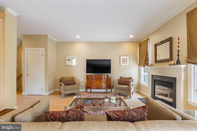 1015 Riverview Ln, Conshohocken, PA 19428 - living room featuring light wood-type flooring, baseboards, recessed lighting, crown molding, and a glass covered fireplace