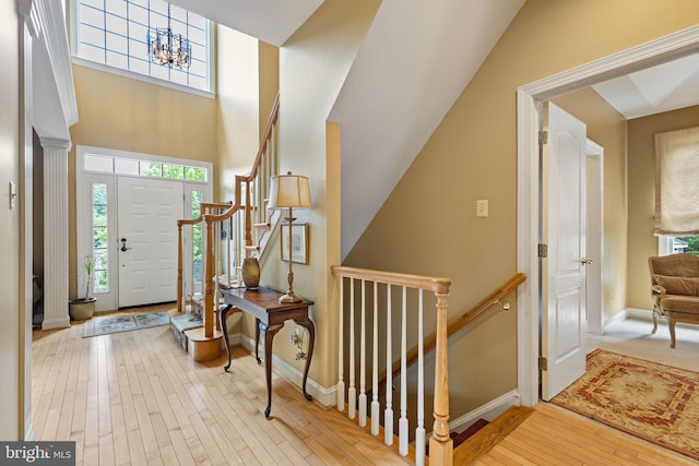 1015 Riverview Ln, Conshohocken, PA 19428 - entryway with wood finished floors, baseboards, a chandelier, stairs, and a high ceiling
