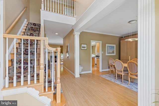 1015 Riverview Ln, Conshohocken, PA 19428 - foyer entrance with stairway, ornamental molding, wood finished floors, baseboards, and decorative columns