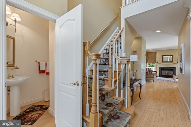 1015 Riverview Ln, Conshohocken, PA 19428 - stairway featuring wood finished floors, a fireplace with raised hearth, baseboards, and recessed lighting