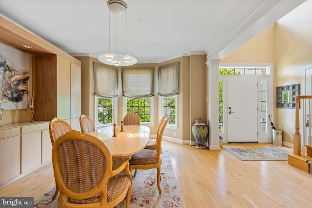 1015 Riverview Ln, Conshohocken, PA 19428 - dining area featuring light wood finished floors, ornamental molding, decorative columns, baseboards, and a chandelier
