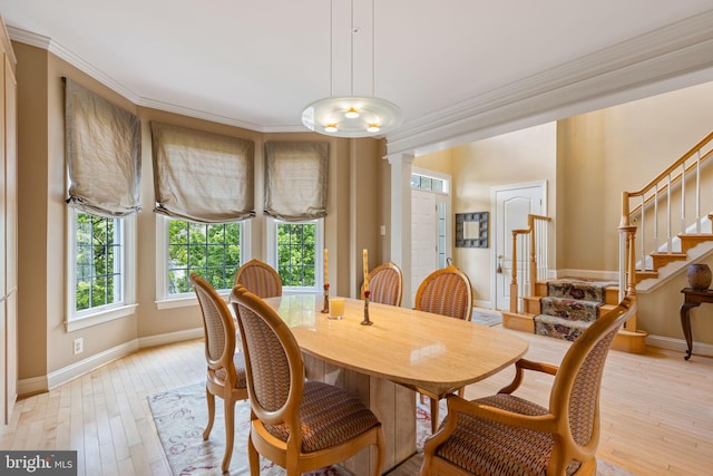 1015 Riverview Ln, Conshohocken, PA 19428 - dining area featuring crown molding, baseboards, light wood-type flooring, stairway, and ornate columns