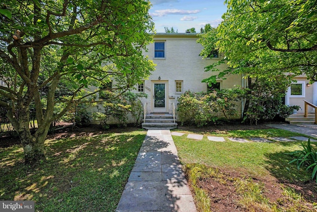 3538 Yuma St NW, Washington, DC 20008 - view of front of property featuring a front lawn, brick siding, and entry steps