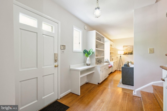 3538 Yuma St NW, Washington, DC 20008 - entrance foyer with light wood-style flooring, baseboards, and stairway