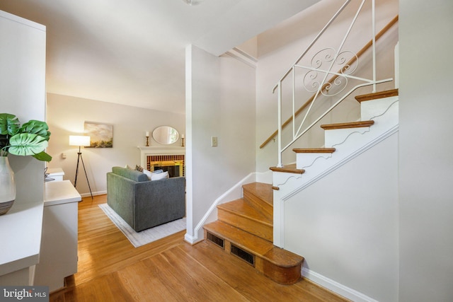 3538 Yuma St NW, Washington, DC 20008 - stairway with wood finished floors, a fireplace, and baseboards
