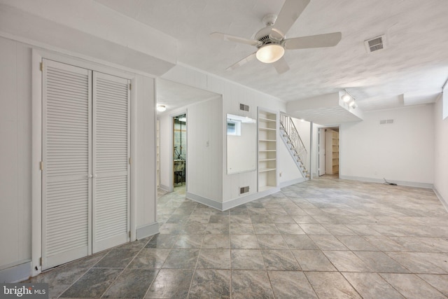 3538 Yuma St NW, Washington, DC 20008 - basement featuring built in shelves, a ceiling fan, baseboards, stone finish floors, and crown molding