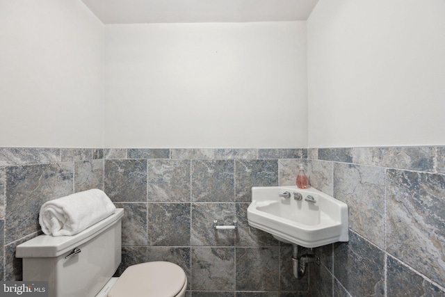 3538 Yuma St NW, Washington, DC 20008 - bathroom featuring tile walls, toilet, and wainscoting