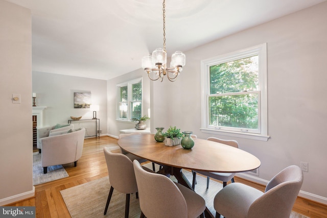 3538 Yuma St NW, Washington, DC 20008 - dining area featuring a chandelier, light wood finished floors, and baseboards
