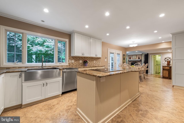 6323 Colchester Rd, Fairfax Station, VA 22039 - kitchen featuring stainless steel dishwasher, a sink, a kitchen island, black electric cooktop, and stone countertops