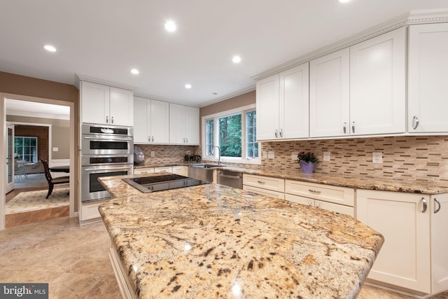 6323 Colchester Rd, Fairfax Station, VA 22039 - kitchen with stainless steel appliances, a center island, light stone counters, recessed lighting, and white cabinetry