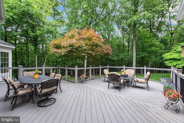 6323 Colchester Rd, Fairfax Station, VA 22039 - wooden terrace with outdoor dining space and view of wooded area