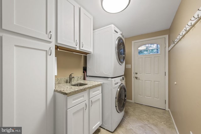 6323 Colchester Rd, Fairfax Station, VA 22039 - laundry room with stacked washer / dryer, cabinet space, baseboards, and light tile patterned floors
