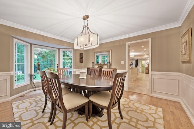6323 Colchester Rd, Fairfax Station, VA 22039 - dining area featuring light wood-style flooring, plenty of natural light, a chandelier, wainscoting, and ornamental molding