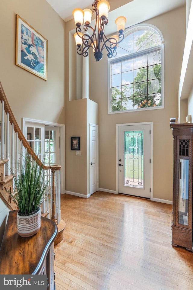 6323 Colchester Rd, Fairfax Station, VA 22039 - foyer with a high ceiling, a chandelier, healthy amount of natural light, light wood-type flooring, and stairway