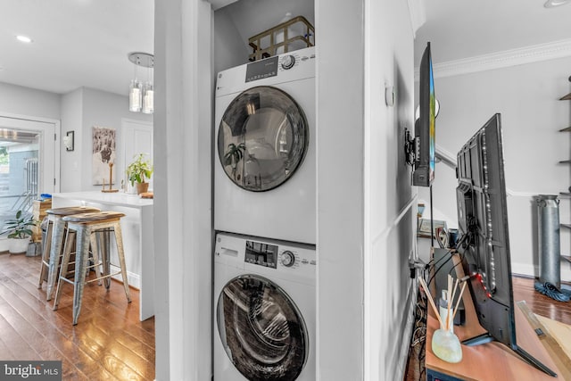 1420 V St SE, Washington, DC 20020 - laundry room featuring stacked washing machine and dryer, wood finished floors, ornamental molding, and recessed lighting