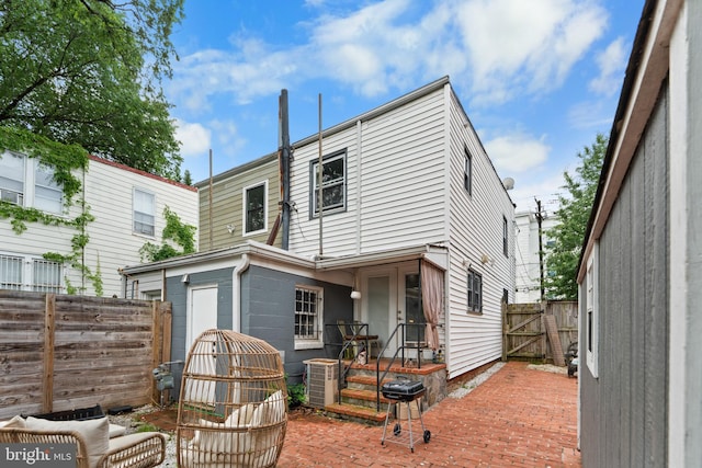 1420 V St SE, Washington, DC 20020 - rear view of house featuring a fenced backyard, cooling unit, a gate, and a patio