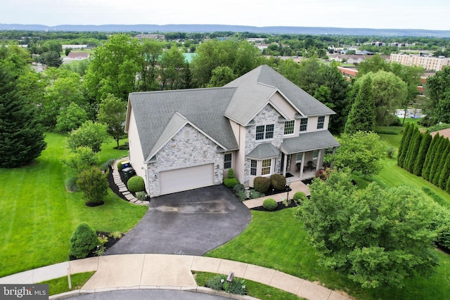 5110 Maple Leaf Ct, Mechanicsburg, PA 17055 - view of front of property with stone siding, a porch, driveway, a garage, and a front yard