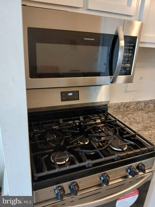 9900 Georgia Ave Unit 27-709, Silver Spring, MD 20902 - kitchen view of appliances with stainless steel finishes, light countertops, and white cabinets
