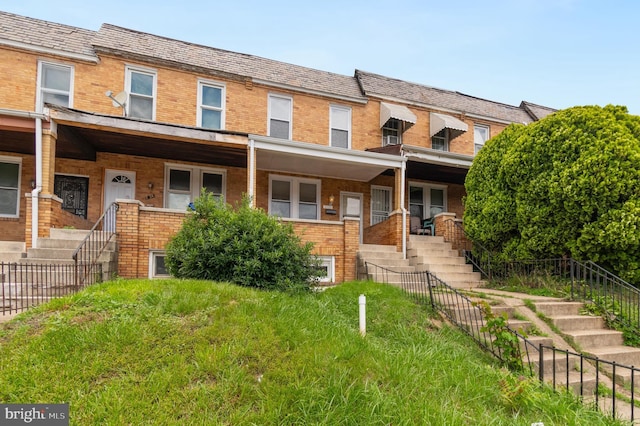 2726 E Preston St, Baltimore, MD 21213 - view of property featuring stairs, brick siding, a high end roof, and covered porch