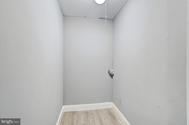 2726 E Preston St, Baltimore, MD 21213 - laundry area featuring light wood-style floors and baseboards