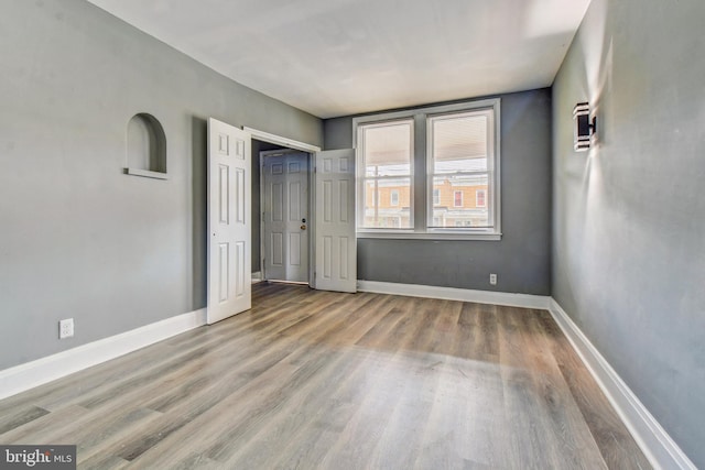 2726 E Preston St, Baltimore, MD 21213 - unfurnished bedroom featuring wood finished floors and baseboards