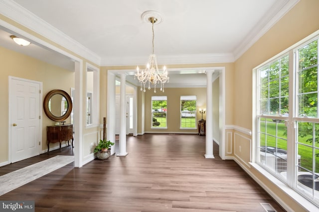 8456 Summer Breeze Pl, Manassas, VA 20112 - foyer featuring wood finished floors, a chandelier, ornamental molding, and decorative columns