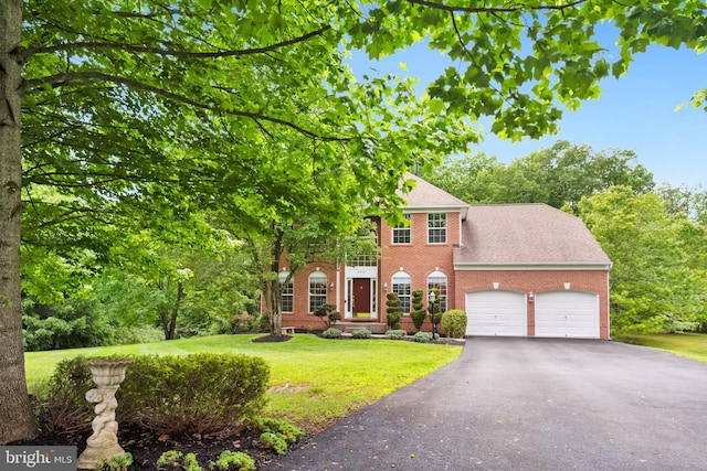 8456 Summer Breeze Pl, Manassas, VA 20112 - view of front of home with brick siding, an attached garage, a front yard, driveway, and a shingled roof
