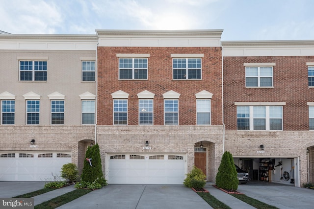 22672 Flowing Spring Sq, Brambleton, VA 20148 - view of property with driveway, brick siding, and a garage